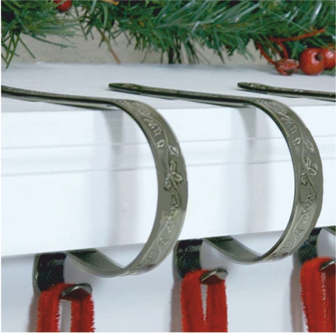 Haute Decor embossed stocking hanger mantel clips for a fireplace.
